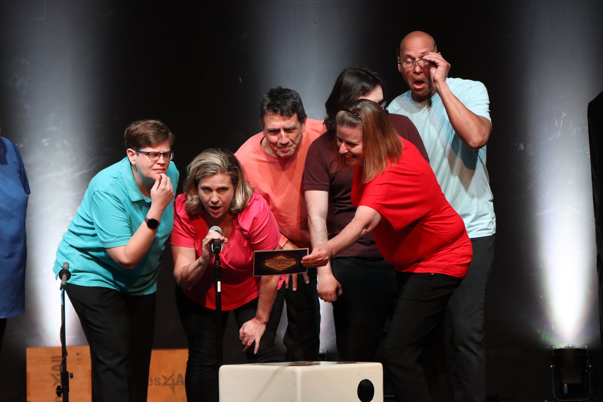 All the Commas Improv STL players looking at a piece of paper all confused