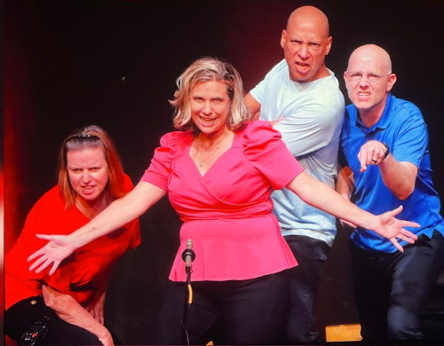 St. Louis Improv troupe interacts with audience members who volunteer to roll the inflatable dice.
